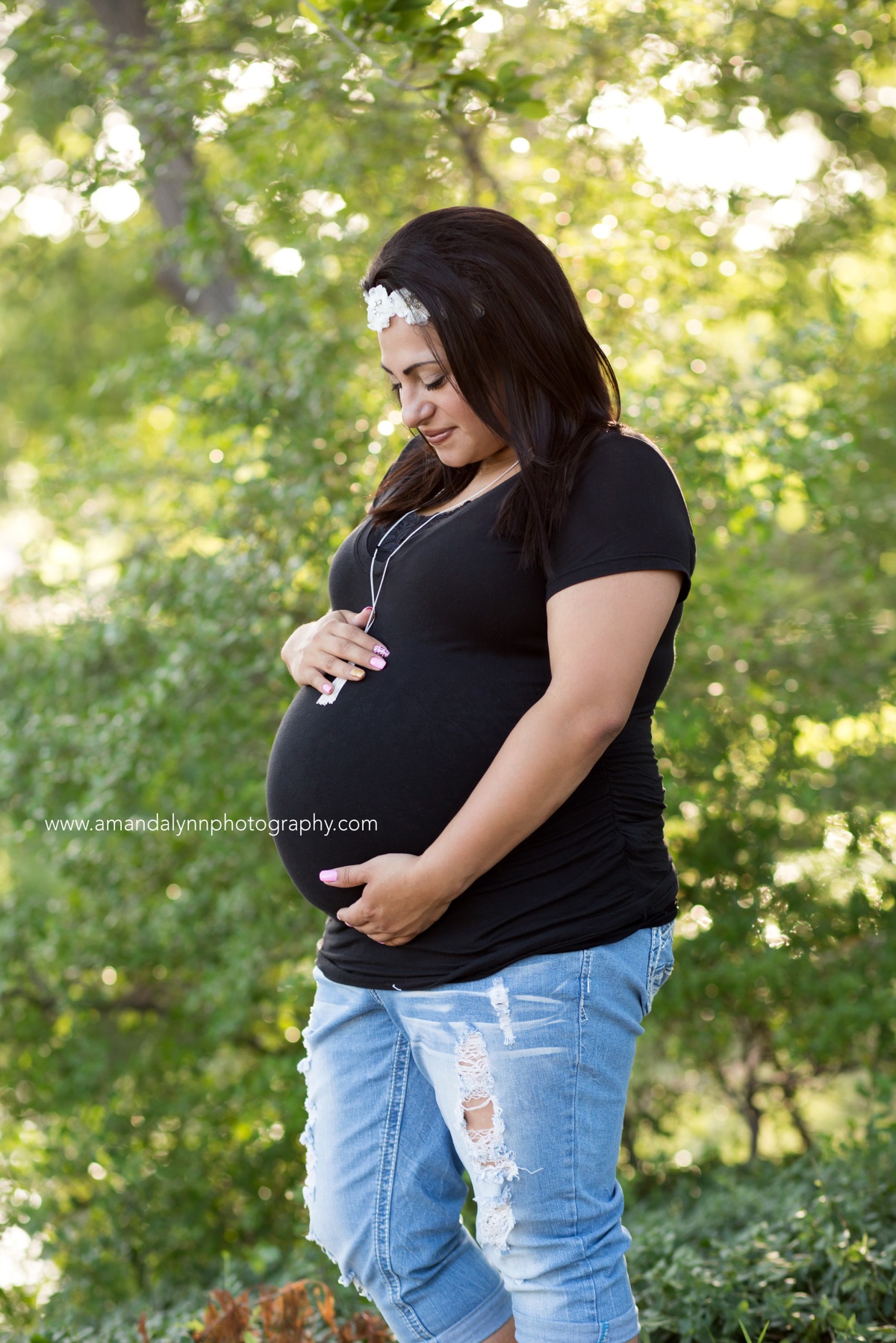 Pregnant woman wearing white flowers in hair posing at a Maternity Photoshoot at Will Rogers Park in Oklahoma City 2016